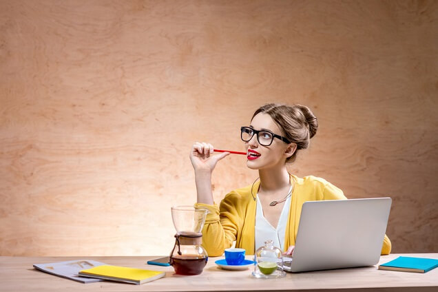 Woman thinking in front of laptop