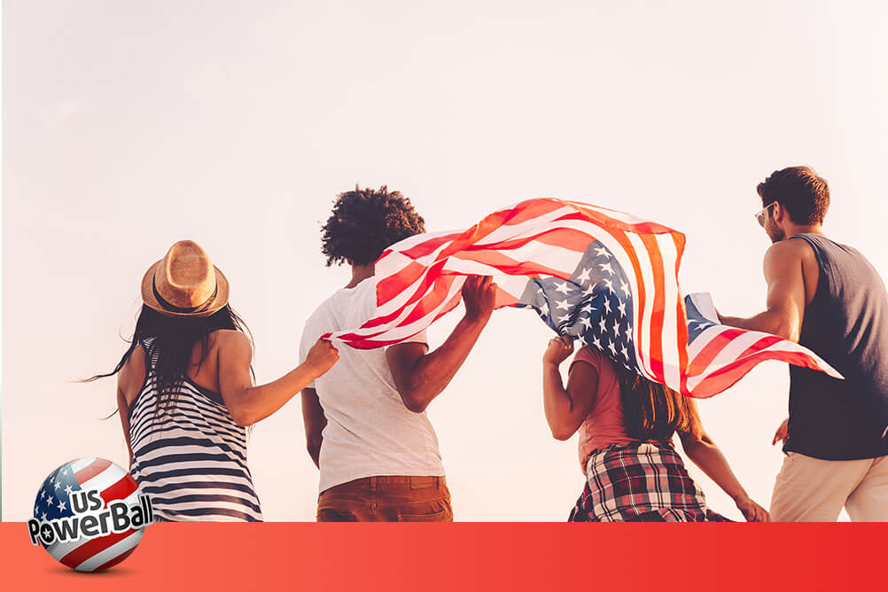 Friends holding the US flag celebrate the largest ever Powerball winner