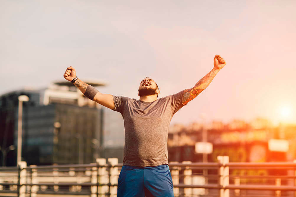 Second Chance Draw Man raising arms in triumph