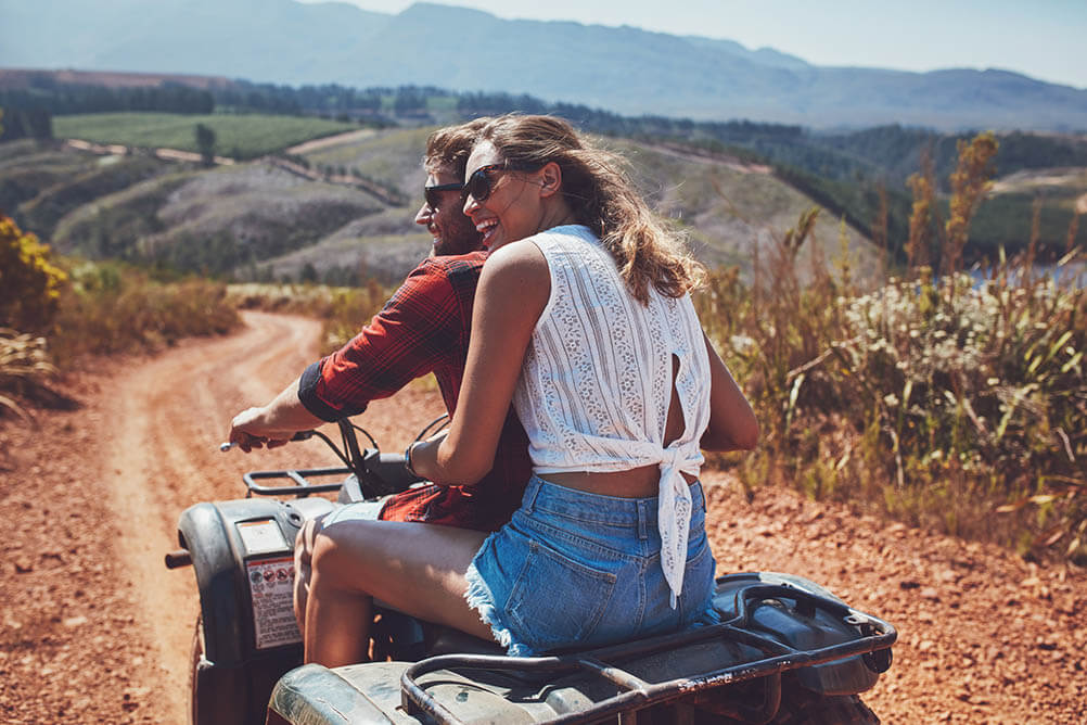 Lottoland Jackpot Hunt Couple riding a quad bike in the countryside