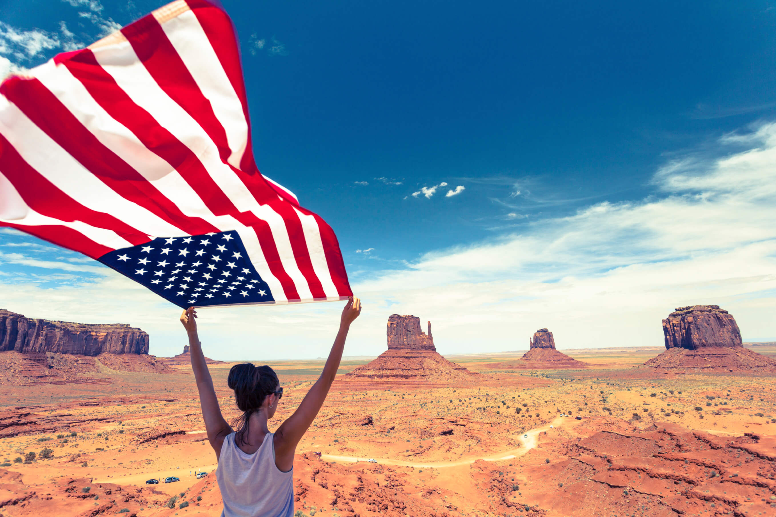 Woman in the desert holding an American flag
