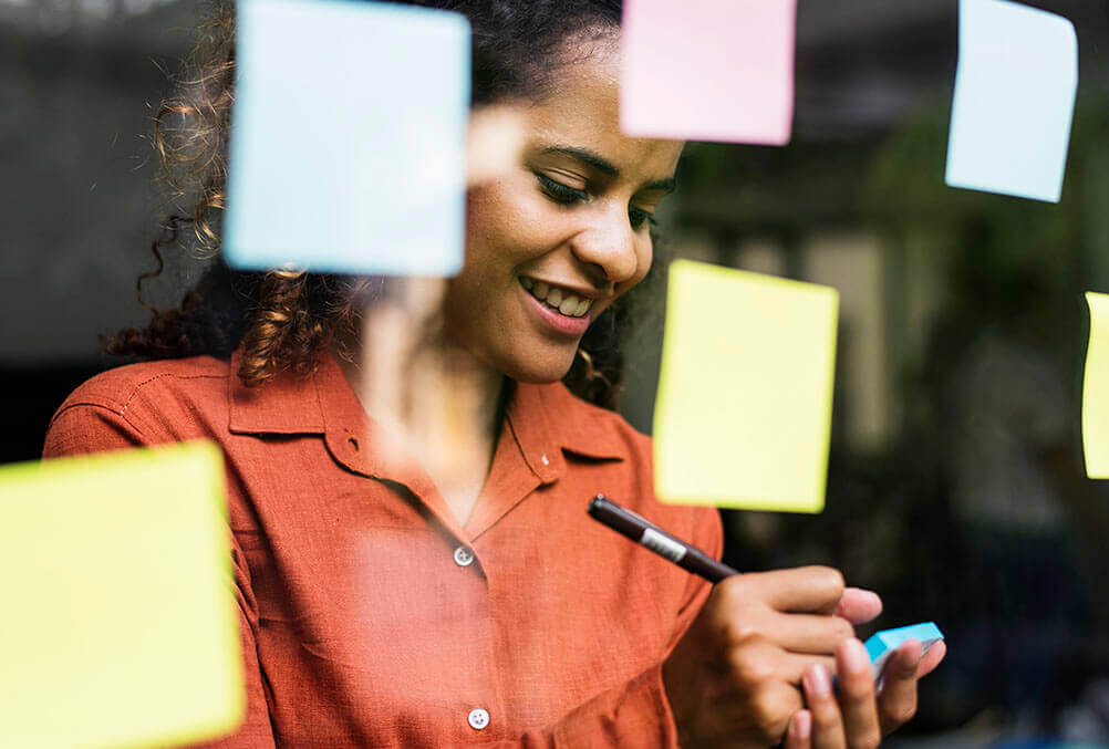 Lottery Calendar: dates of all the lottery draws Woman makes notes of the next lottery draw on a post-it note