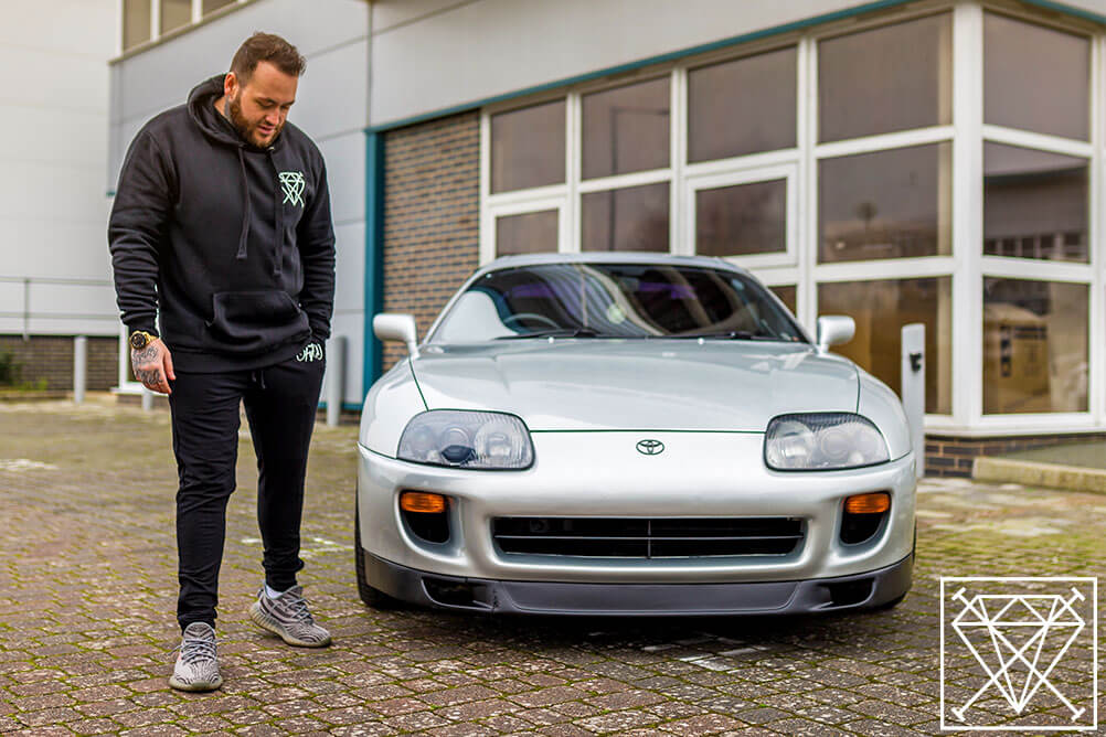 What car would you buy if you won the lottery Jamie Balmer standing next to a Toyota Supra which looks like a millionaire car