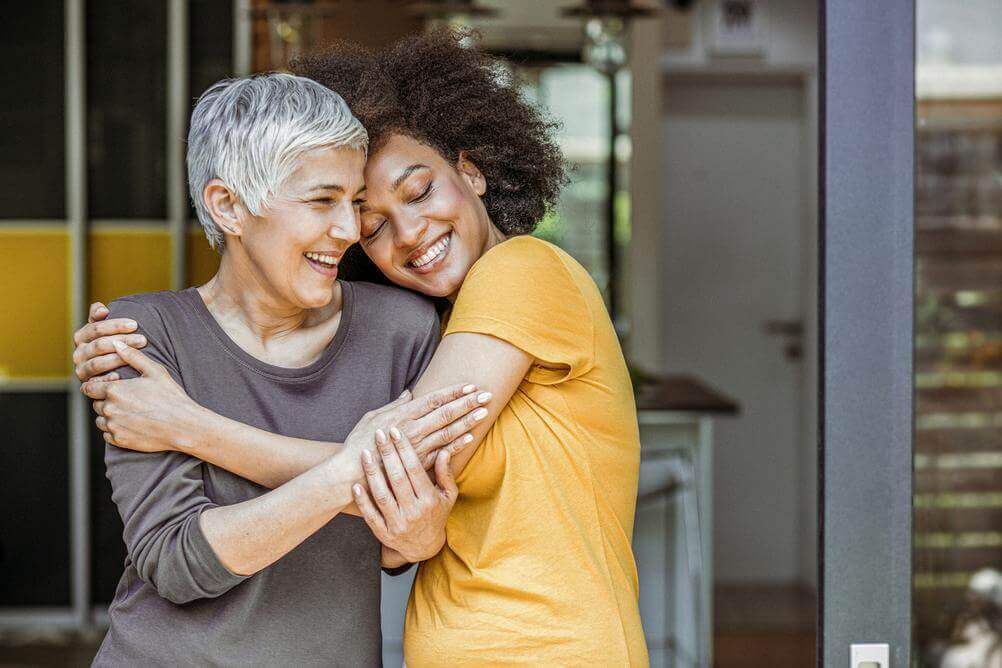 Women hugging as they celebrate International Women's Day on March 8th