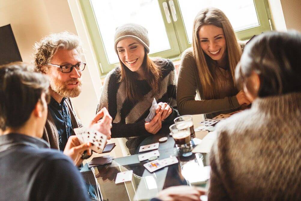 What are the odds of being dealt a royal flush in poker? Group of friends playing poker hoping to be dealt a royal flush against the odds