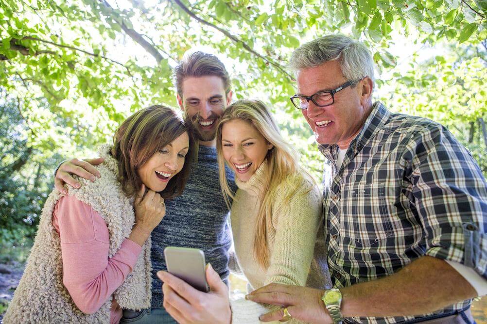 Family-looking-at-phone-winning-lottery