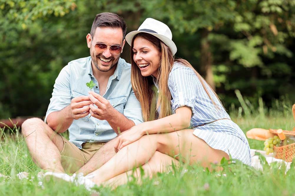 Jackpot Winner or Four Leaf Clover Finder Couple in field find four leaf clover
