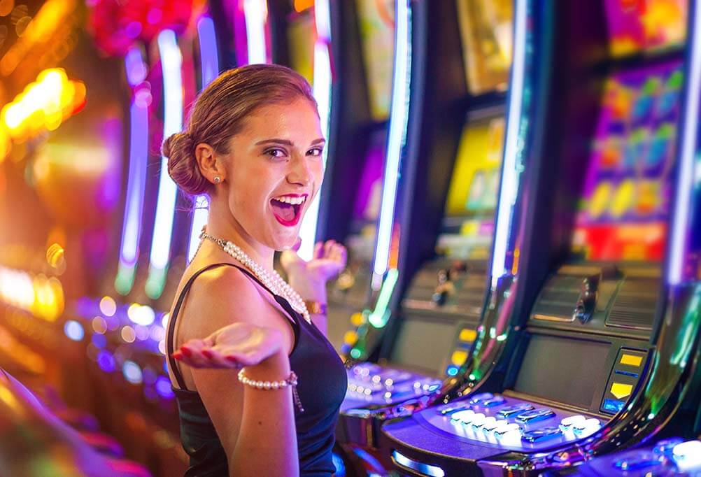 Woman in casino playing slot machines and casino games