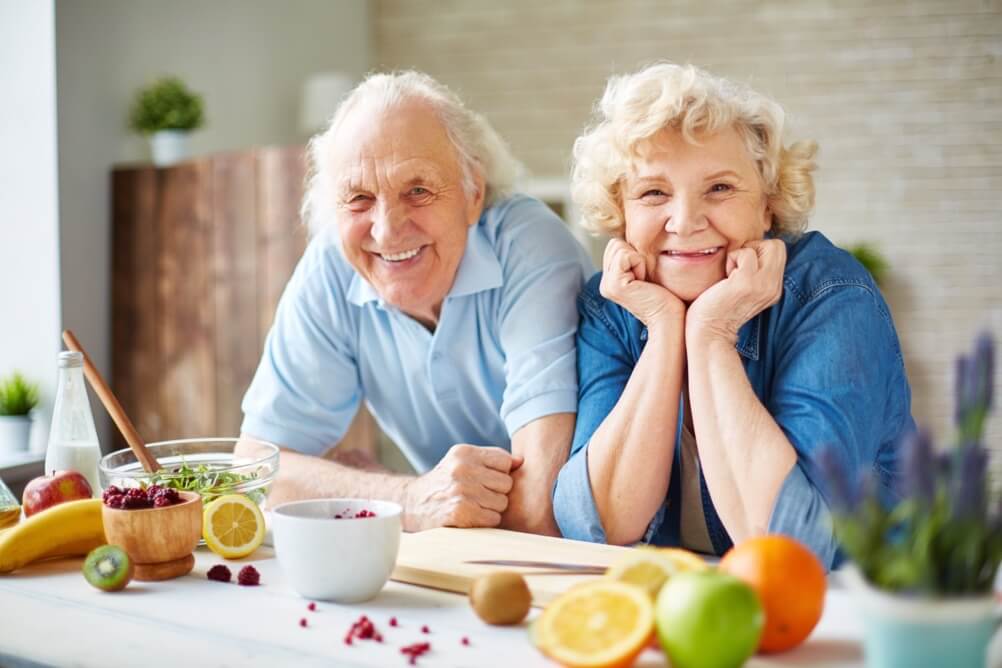 Smiling senior couple enjoying a healthy breakfast
