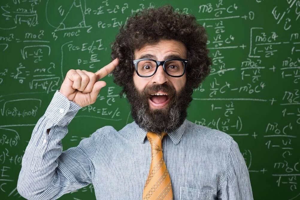 Man with long beard in front of probabilities board