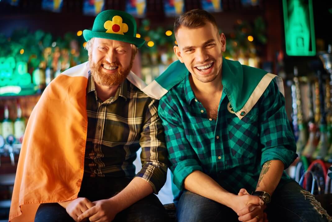 Irish men happily reading about the best Irish slots