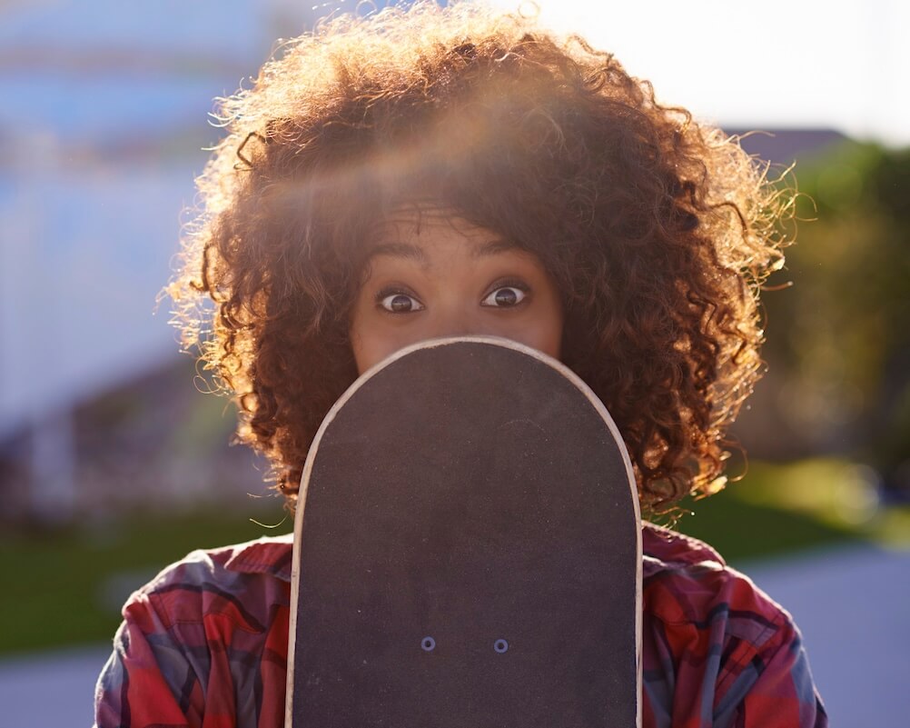 Martingale Strategy A woman, hiding some of her face behind a skateboard, shocked to discover the Martingale strategy does not work.